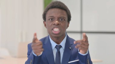 Distraught Young African Businessman Talking in Anger and Stress