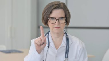 Restricting Old Senior Doctor with Denying Gesture
