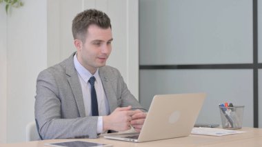 Young Businessman Doing Video Chat on Laptop