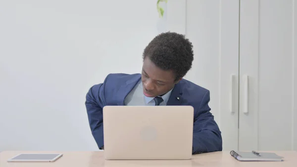 Young African Businessman with Back Pain at Work