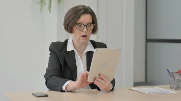 Shocked Old Businesswoman Reacting to Loss on Digital Tablet
