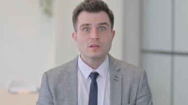 Portrait of Young Businessman Reacting to Financial Loss