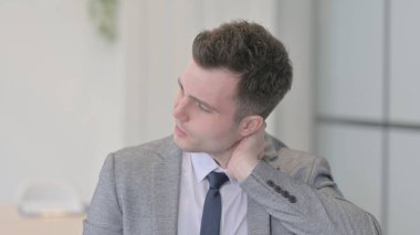 Portrait of Young Businessman with Neck Pain