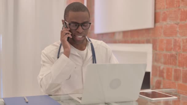 Νεαρός Αφρικανός Γιατρός Μιλάει Στο Τηλέφωνο Στη Δουλειά — Αρχείο Βίντεο