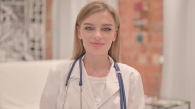 Thumbs Up by Female Doctor in Clinic