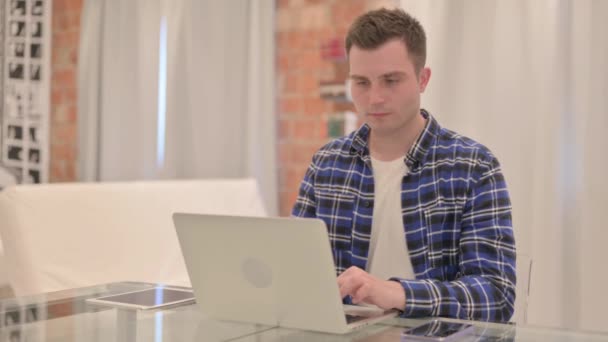 Chockad Ung Tillfällig Man Arbetar Laptop — Stockvideo