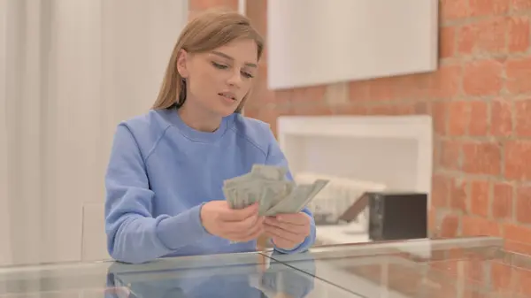 stock image Young Woman Counting Money at Home, Dollars