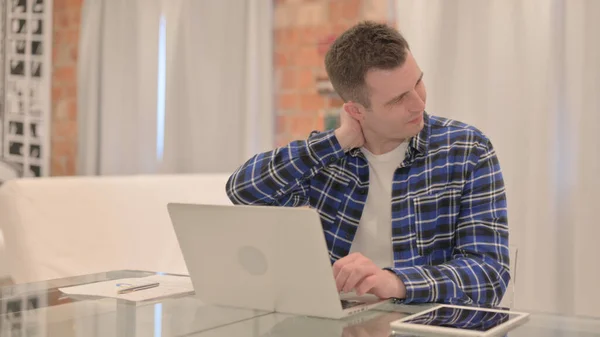 stock image Young Casual Man with Neck Pain Working on Laptop