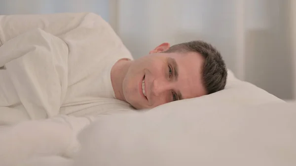 Smiling Young Man Lying Bed Side — Stock Photo, Image