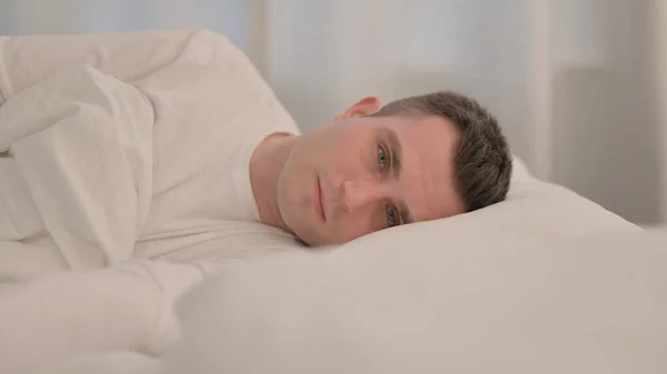 Serious Young Man Lying Bed Side — Fotografie, imagine de stoc