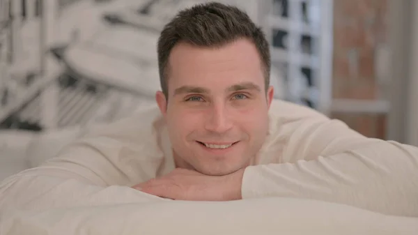 Young Man Lying Bed Stomach Smiling Camera — Stock Photo, Image