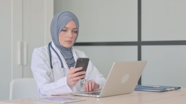 Moslim Vrouwelijke Arts Met Behulp Van Smartphone Kliniek — Stockvideo