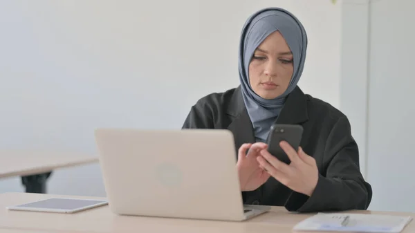 stock image Muslim Businesswoman Working on Laptop and Using Smartphone