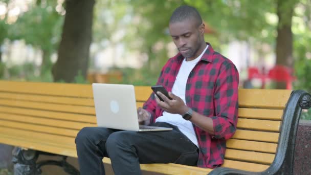Hombre Joven Africano Que Trabaja Ordenador Portátil Smartphone — Vídeos de Stock