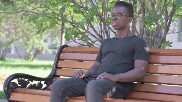 Young African Man Sitting Outdoor Back Pain — Stock Video