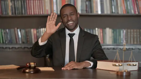 African Male Lawyer Waving Hand to Say Hello in Office