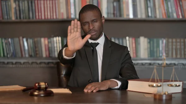 Stop Gesture by African Male Lawyer