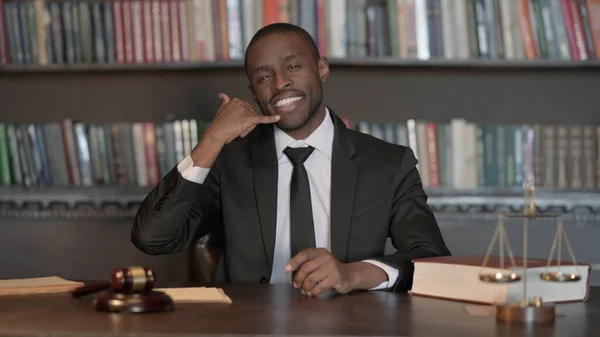 Call Me Gesture by African Male Lawyer in Office