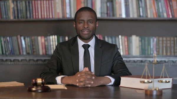 Serious African Male Lawyer Sitting in Office