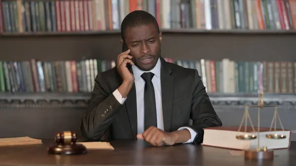 African Male Lawyer Excited for Online Shopping on Phone in Office
