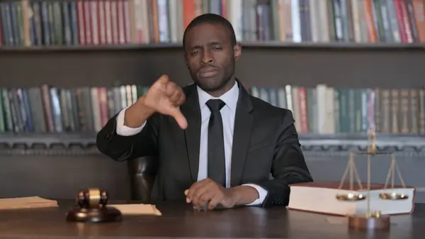 Thumbs Down by African Male Lawyer in Office