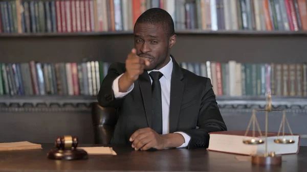 Selecting African Male Lawyer Pointing at Camera