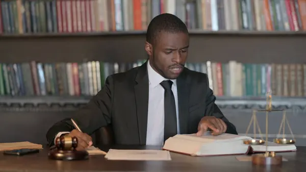 African Male Lawyer Working on Documents in Office