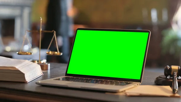 Close up of Laptop with Green Screen in Court Room