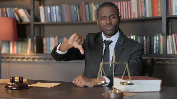 African American Lawyer Doing Thumbs Down in Office