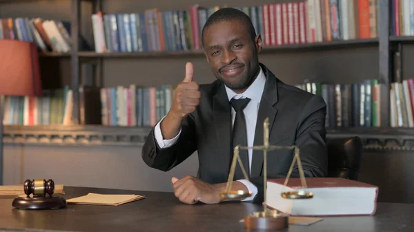 African American Lawyer with Thumbs Up in Office