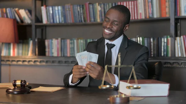 Happy African American Lawyer Counting Money in Office