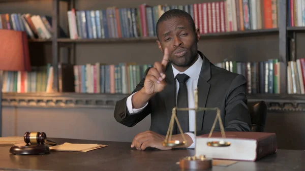 African American Lawyer in Denial Looking at Camera in Office