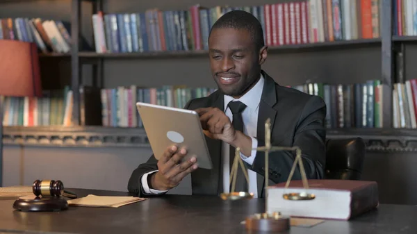 African American Lawyer using Tablet in Office