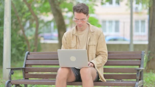 Casual Young Man Smiling Camera While Working Laptop Outdoor — Stok Video
