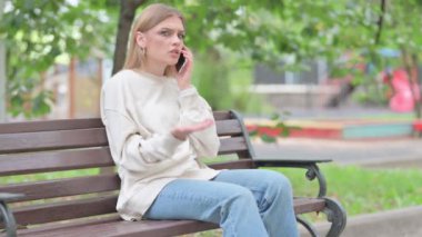 Angry Young Woman Talking on phone Outdoor