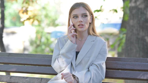 Angry Young Businesswoman Talking on phone Outdoor
