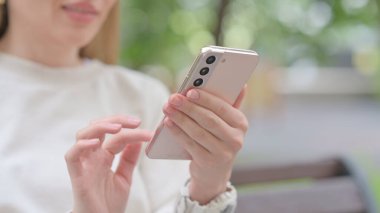 Close Up of Young Woman Browsing Smartphone
