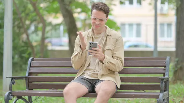 Casual Young Man Shocked Loss Smartphone While Sitting Outdoor Bench — Stock Photo, Image