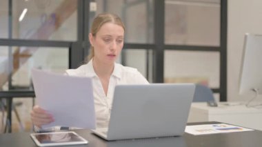 Olgun İş Kadını Belgeler ve Laptop Üzerinde Çalışıyor