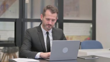 Dizüstü bilgisayarla uğraşırken İşadamından Başparmak İndirme