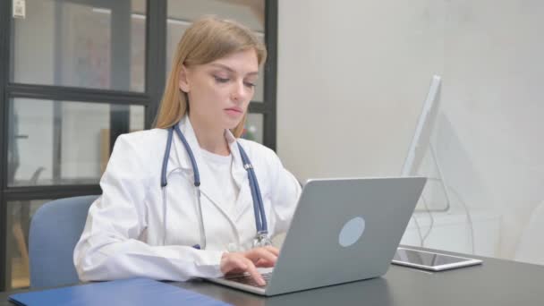 Female Doctor Looking Camera While Working Laptop — Stock Video