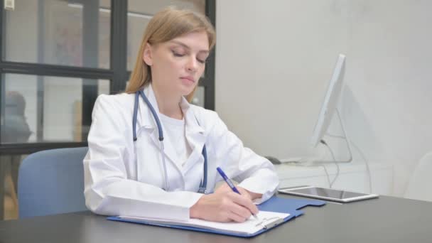 Female Doctor Writing Document Medical Report — Stock Video