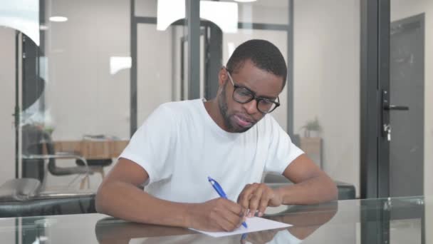 Young African Man Writing Letter Office — Stock Video