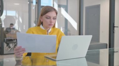 Dizüstü bilgisayar ve Belgeler Kullanılırken Genç Kadın Kutlama