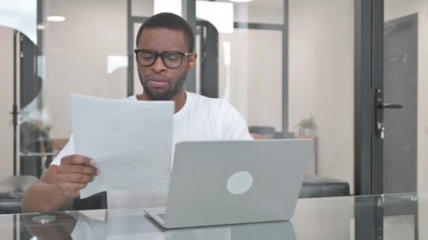 Young African Man Working Documents Laptop — Stock video