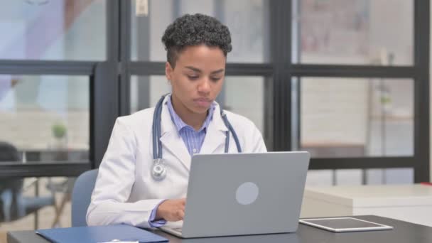 Call Gesture Mixed Race Female Doctor While Using Laptop — Stock Video