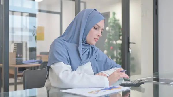 Woman in Hijab Doing Business Paperwork