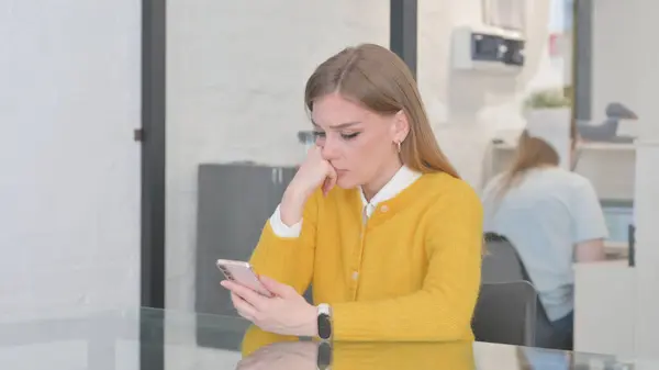 Blonde Casual Woman Shocked by Online Investment Loss on Phone
