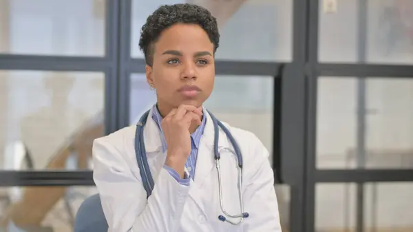 Pensive African Female Doctor Thinking Treatment Plan