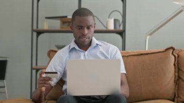 Afrikalı Adam Evdeki Kanepede otururken İnternetten Telefonla Alışveriş Yapıyor